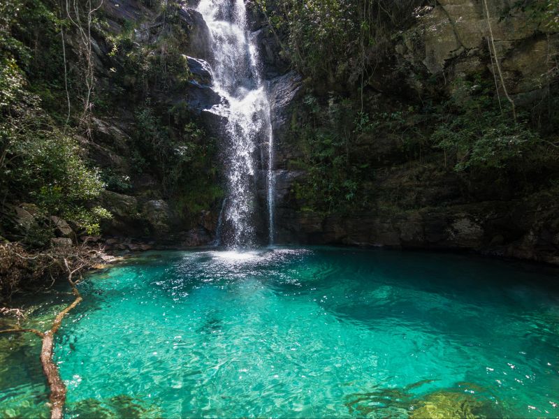 cachoeira na chapada dos veadeiros. Poço de água esverdeada e cristalina no fundo de um paredão de pedra que cerca a queda d